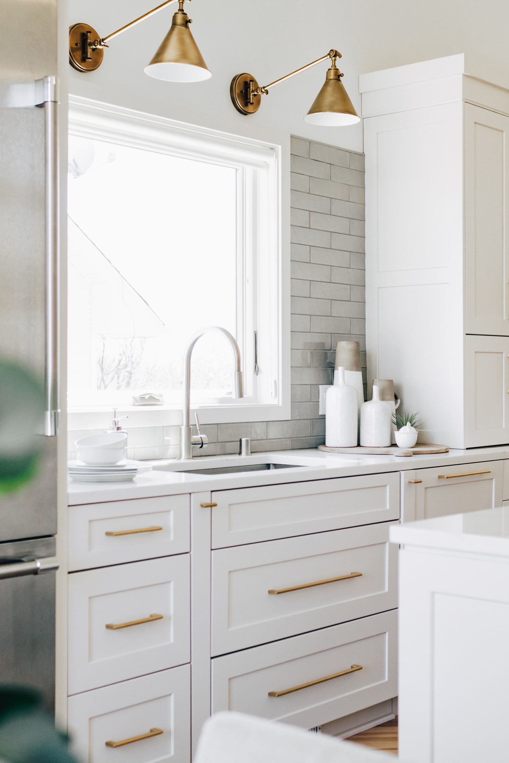 Custom Cabinetry Design White Kitchen with Full Wall Subway Tile Backsplash