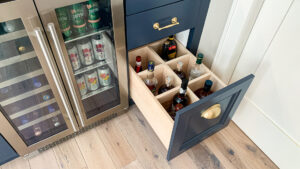 Dry bar with unique bottle storage drawer and under-cabinet wine refrigerator