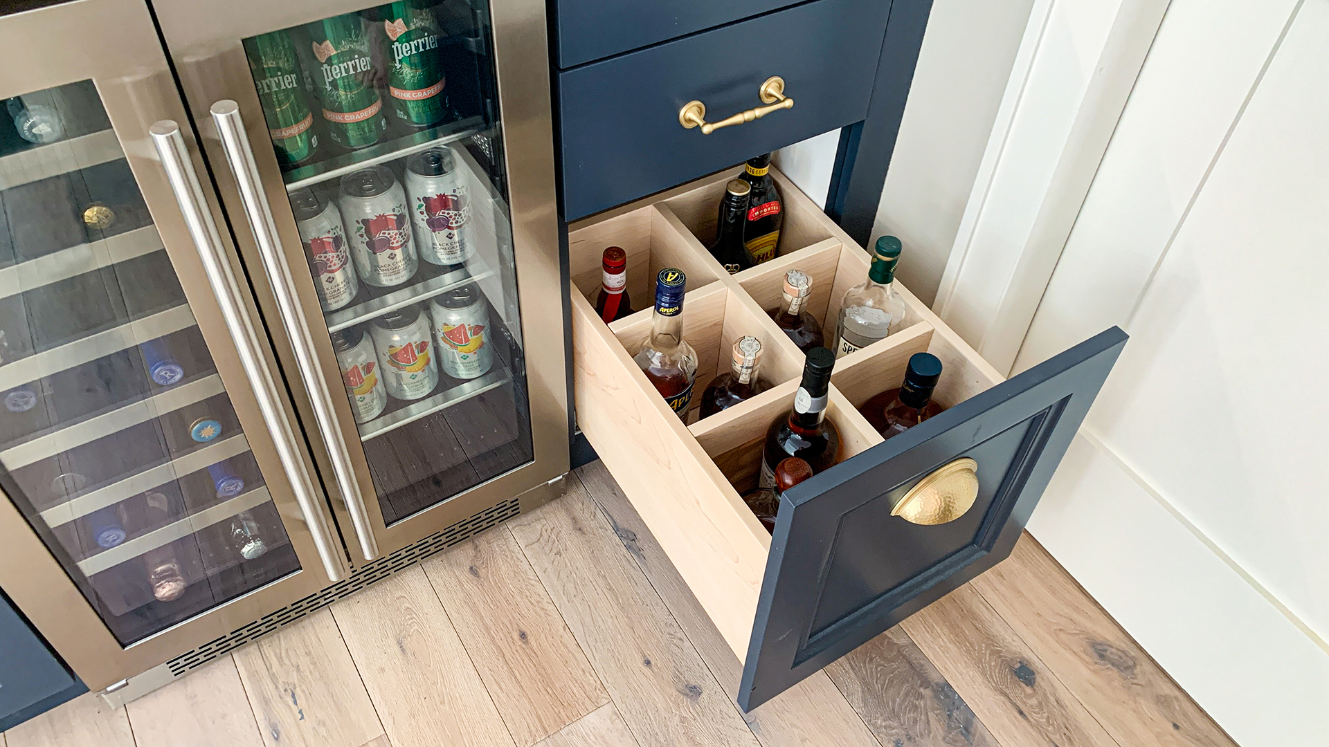 Studio M Tonka Bay Beach House dry bar Dry bar with unique bottle storage drawer and under-cabinet wine refrigerator